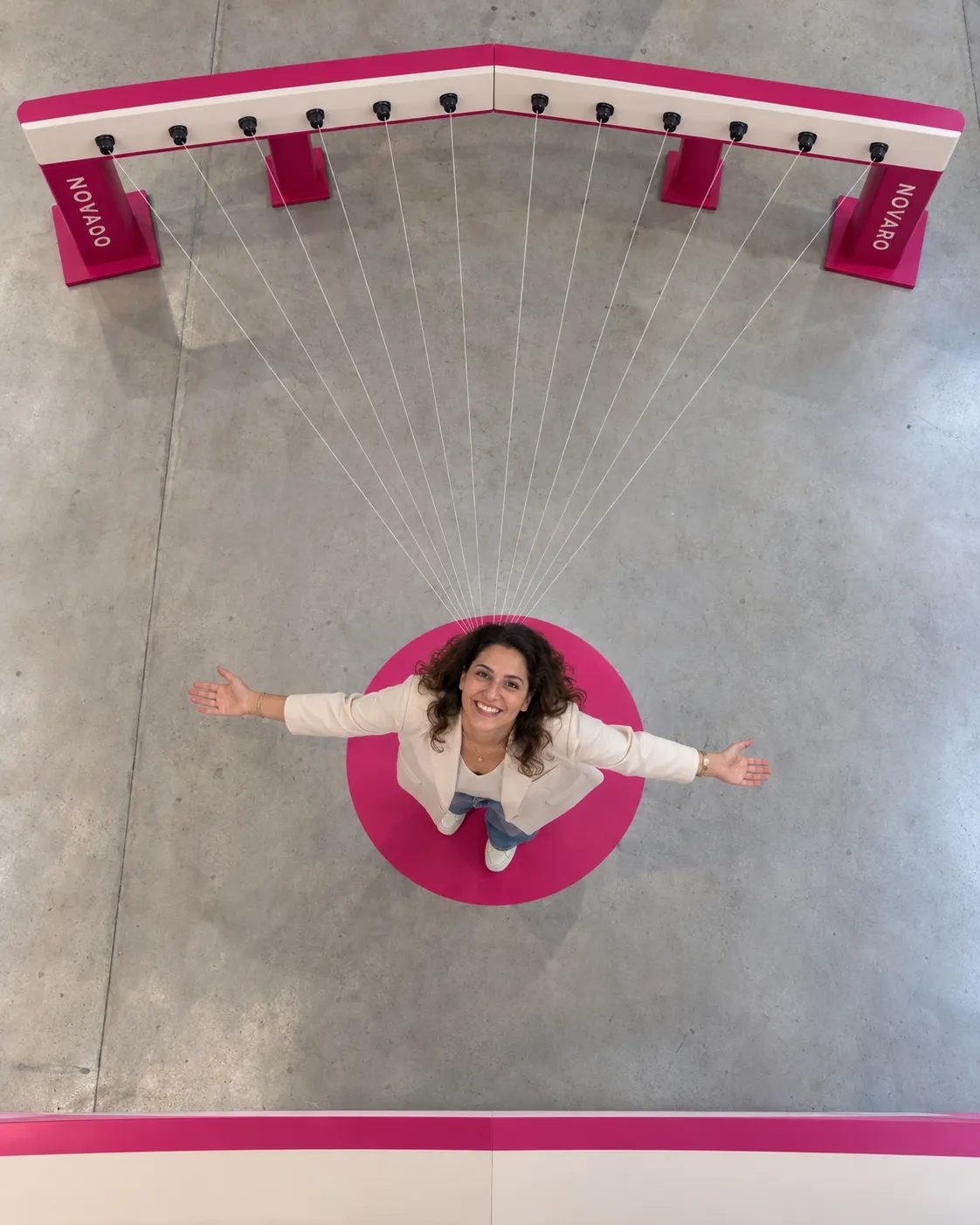 Seen from above, the twelve cameras of the Bullet booth, set in an open arc, all aim at one point where a guest poses on a floor marker