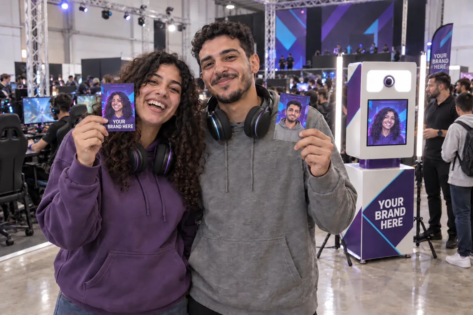 Two gamers show their illustrated cards beside a Selfie Box in your brand colours at a gaming event