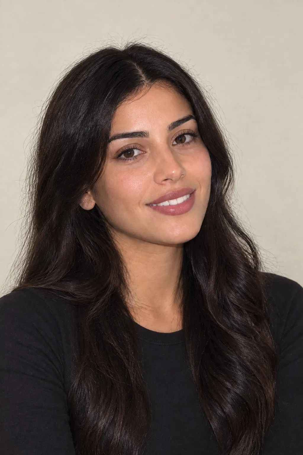 Starting portrait of the same woman wearing a black top