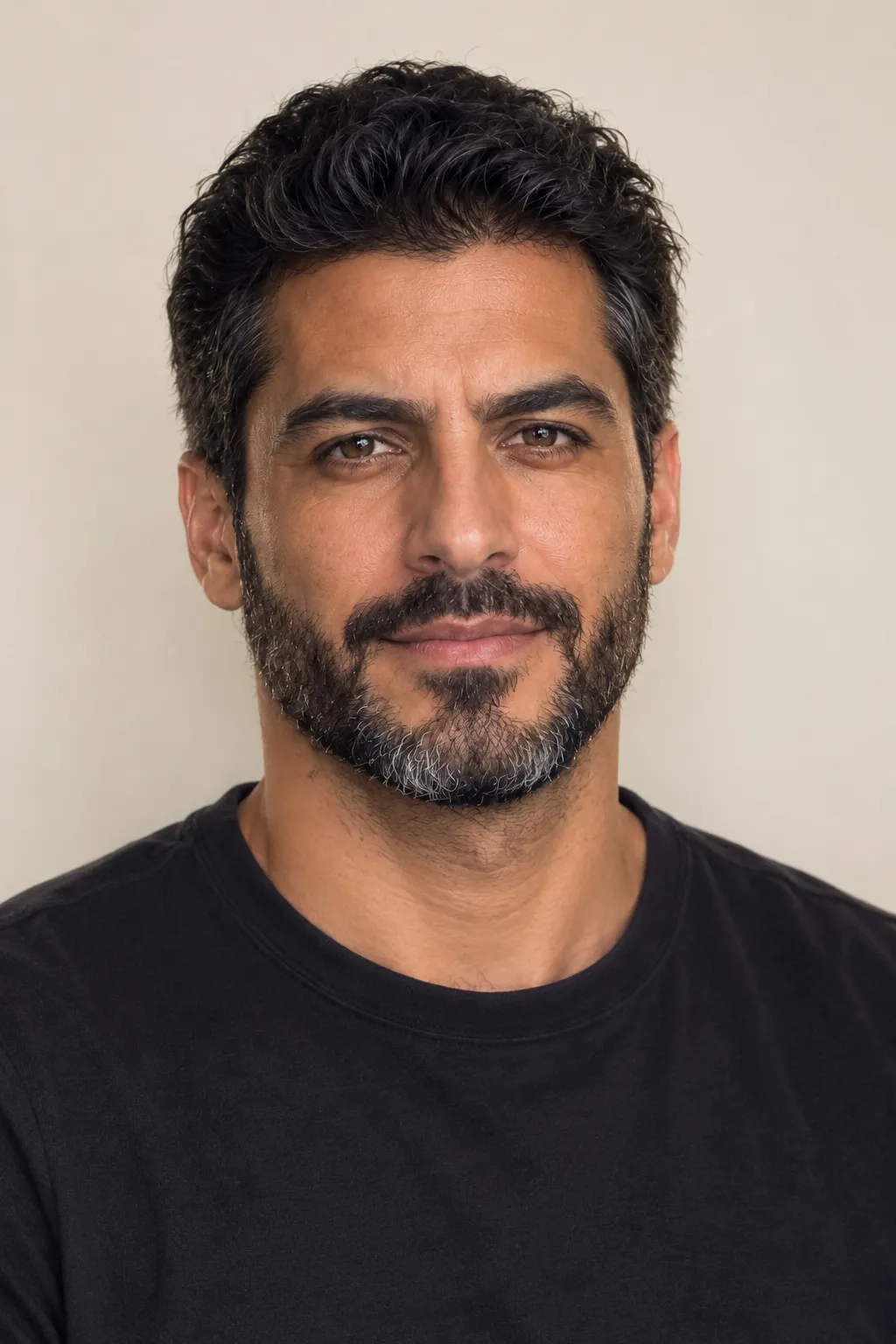 Starting portrait of the same man against a plain wall
